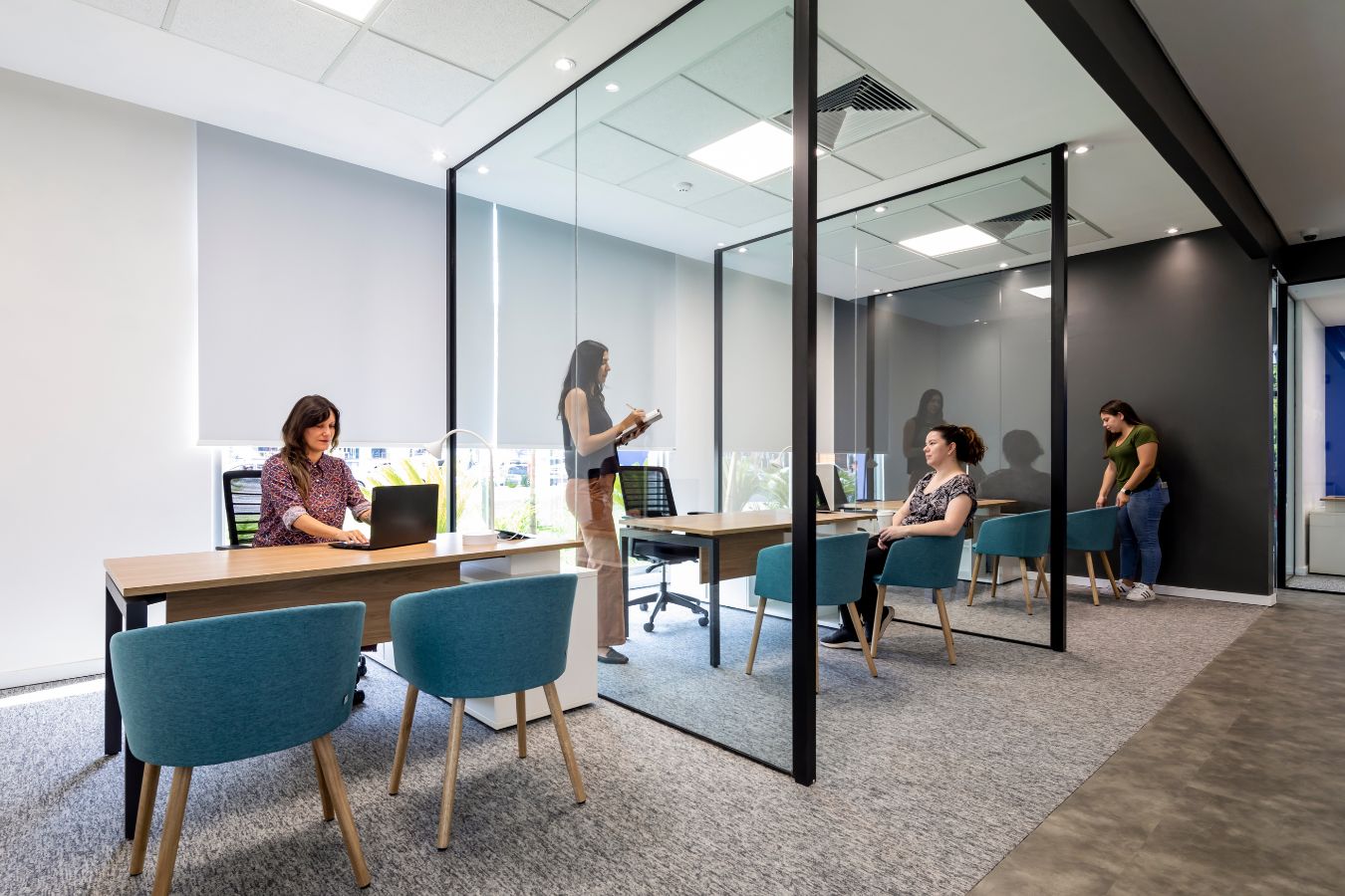 seguradora Yacyreta - Transparent private office with black metal framing and modern furniture - Contract Workplaces.jpg